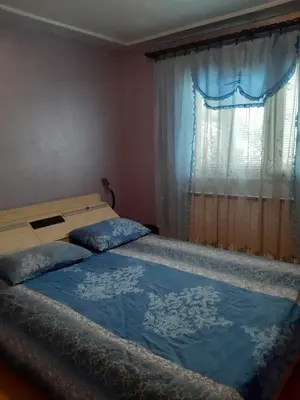 two beds in a bedroom with a window at Vila Mir in Pirot