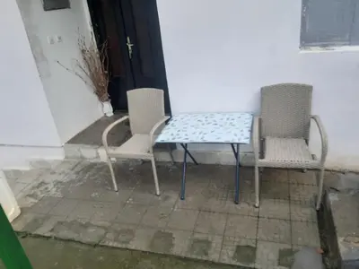two chairs and a table in front of a door at Vila Mir in Pirot