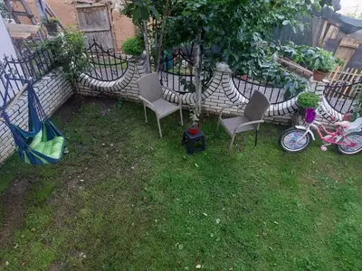 a yard with chairs and a bike parked next to a fence at Vila Mir in Pirot