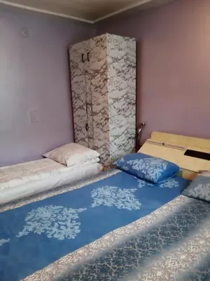 a room with two beds and a door at Vila Mir in Pirot