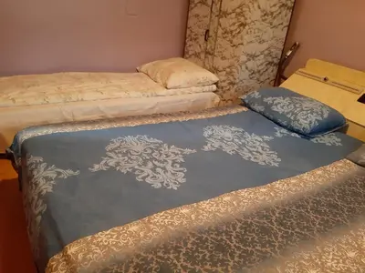 a room with two beds and a couch at Vila Mir in Pirot