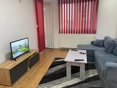a living room with a couch and a tv at Apartman Kasija in Jagodina