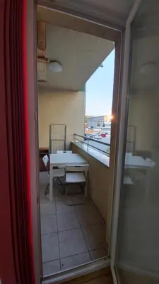 a view of a room with a table and a window at Apartman Kasija in Jagodina