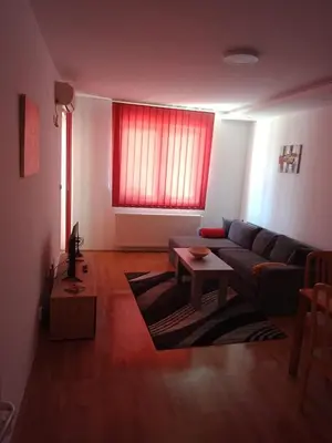 a living room with a couch and a red window at Apartman Kasija in Jagodina