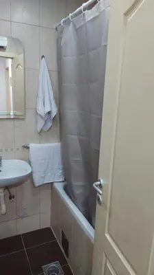 a bathroom with a shower curtain and a sink at Apartman Kasija in Jagodina