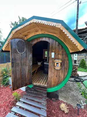 a large wooden dog house with a large door at VILA MILICA & SPA ALEKSANDRA in Dimitrovgrad