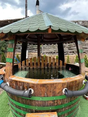 a wooden gazebo with a pool of water in it at VILA MILICA & SPA ALEKSANDRA in Dimitrovgrad