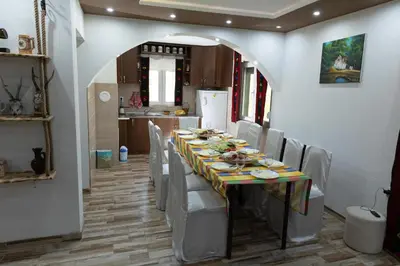 a dining room with a long table and chairs at Vila Dimitrijevic Lisine in Despotovac