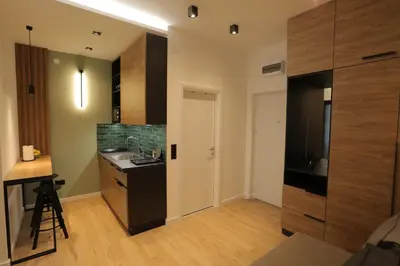 a small kitchen with a sink and a counter at Bonanza Apartments in Niš