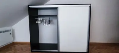a black and white mirror in a room at A&A in Vrnjačka Banja