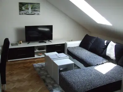 a living room with a couch and a flat screen tv at A&A in Vrnjačka Banja