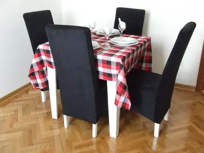 a dining room table with a red and black checkered table cloth at A&A in Vrnjačka Banja