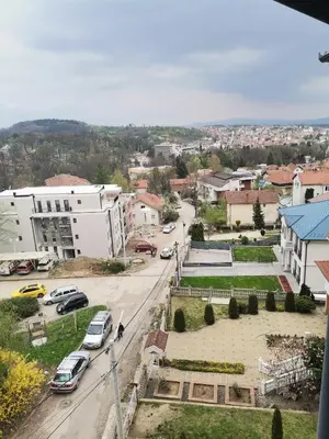 an aerial view of a city with cars parked on a street at APARTMANI CEPERKOVIC in Vrnjačka Banja