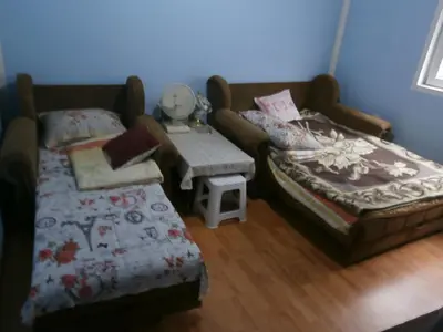 a living room with a bed and a table at Soba Dimitrijević in Soko Banja
