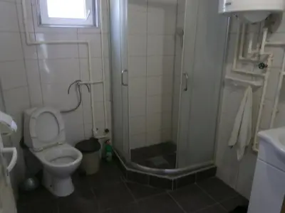 a bathroom with a toilet and a glass shower at Soba Dimitrijević in Soko Banja