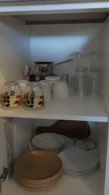 a shelf with plates and other items on it at Ctrl Alt Del Apartment S76 in Kopaonik
