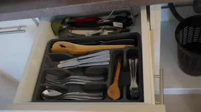 a drawer filled with utensils in a cabinet at Ctrl Alt Del Apartment S76 in Kopaonik