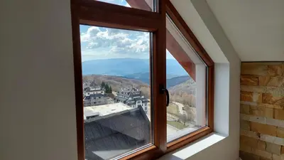 a window with a view of a mountain at Ctrl Alt Del Apartment S76 in Kopaonik