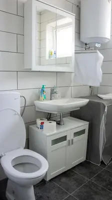 a bathroom with a white toilet and a sink at Dvosoban stan u strogom centru in Kruševac