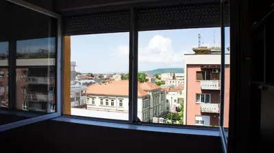 a view of a city from an office window at Dvosoban stan u strogom centru in Kruševac