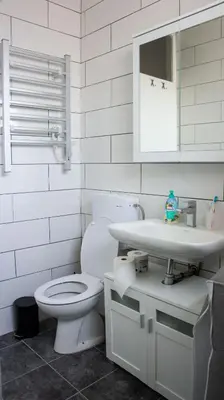 a white bathroom with a toilet and a sink at Dvosoban stan u strogom centru in Kruševac