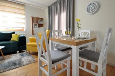 a kitchen and living room with a table and chairs at Apartman Antic 1 in Vrnjačka Banja