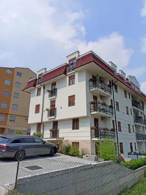 a car parked in front of a building at Apartman Antic 1 in Vrnjačka Banja