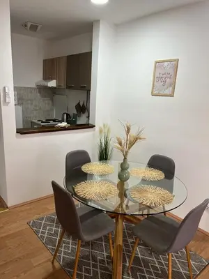 a dining room with a glass table and chairs at Apartman - 411 in Vrnjačka Banja