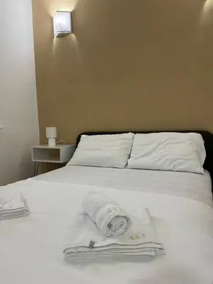 a white bed with towels on top of it at Apartman - 411 in Vrnjačka Banja