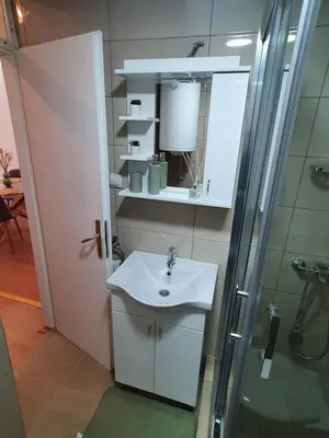 a bathroom with a sink and a shower at Apartman - 411 in Vrnjačka Banja
