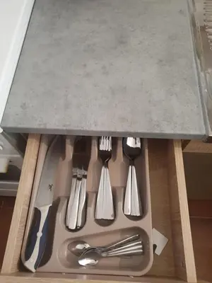 a group of utensils sitting on top of a counter at Apartman - 411 in Vrnjačka Banja