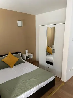 a bedroom with a bed and a large mirror at Apartman - 411 in Vrnjačka Banja