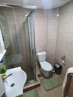 a bathroom with a shower and a toilet and a sink at Apartman - 411 in Vrnjačka Banja