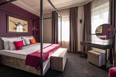 a hotel room with a bed and a mirror at ArtLoft Garni Hotel in Niš