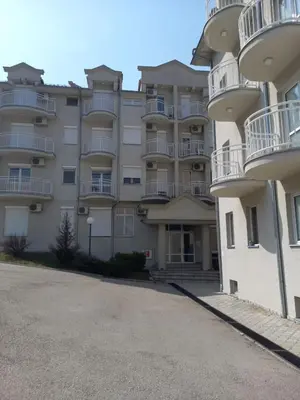 a large apartment building with balconies and a parking lot at Smeštaj Voli - Borići studio-apartman, Sokobanja in Soko Banja