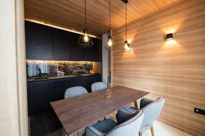 a dining room with a wooden table and chairs at Aparthotel Woodside by Anaya in Kopaonik