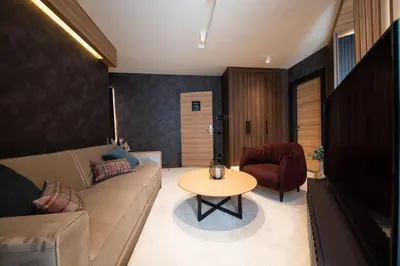 a living room with a couch and a table at Aparthotel Woodside by Anaya in Kopaonik