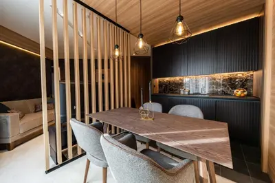 a dining room with a wooden table and chairs at Aparthotel Woodside by Anaya in Kopaonik