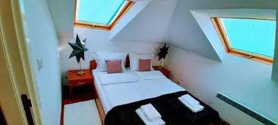 a small room with a bed and a window at Apartman President in Vrnjačka Banja