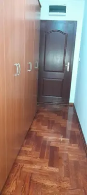 a room with a door and a wooden floor at Apartman President in Vrnjačka Banja