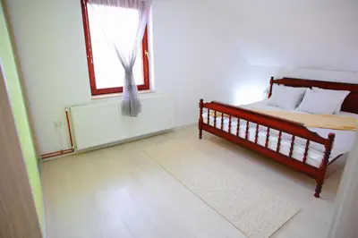 a bedroom with a bed and a window at Djokić 2 sa bazenom in Soko Banja
