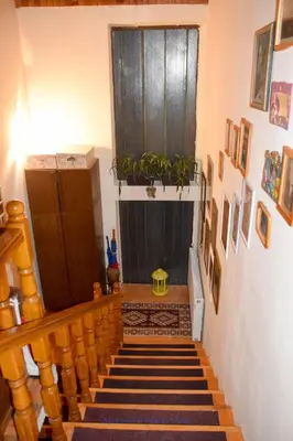 a hallway with a staircase with a window and a plant at Apartman Wisteria in Vranje