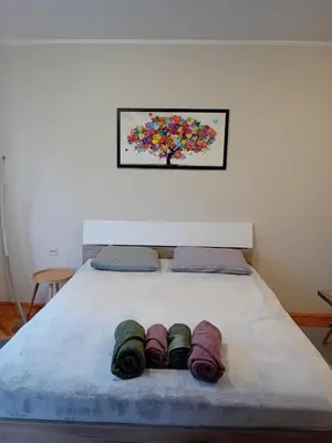 a bed with three coils of blankets on it at Apartman A-1 in Zaječar