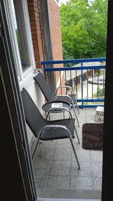 a pair of chairs sitting on a balcony at Apartman A-1 in Zaječar
