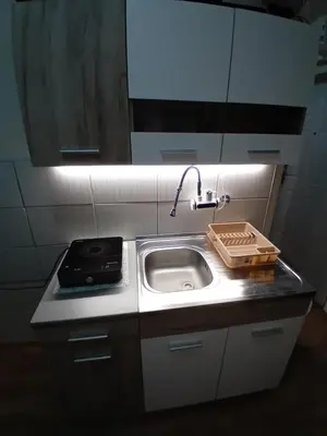 a kitchen counter with a sink and a sink at Apartman A-1 in Zaječar