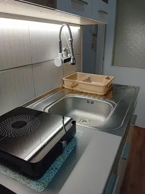 a kitchen counter with a sink and a sink at Apartman A-1 in Zaječar
