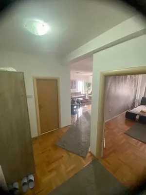an empty room with a living room and a bedroom at City view & pool apartment in Niš