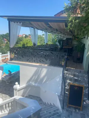 a view of a swimming pool from a house at City view & pool apartment in Niš