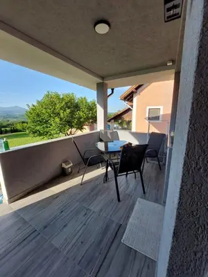 a patio with a table and chairs on a balcony at Djokić 3 sa bazenom in Soko Banja