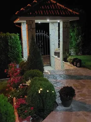 a front door of a house at night at Djokić 3 sa bazenom in Soko Banja